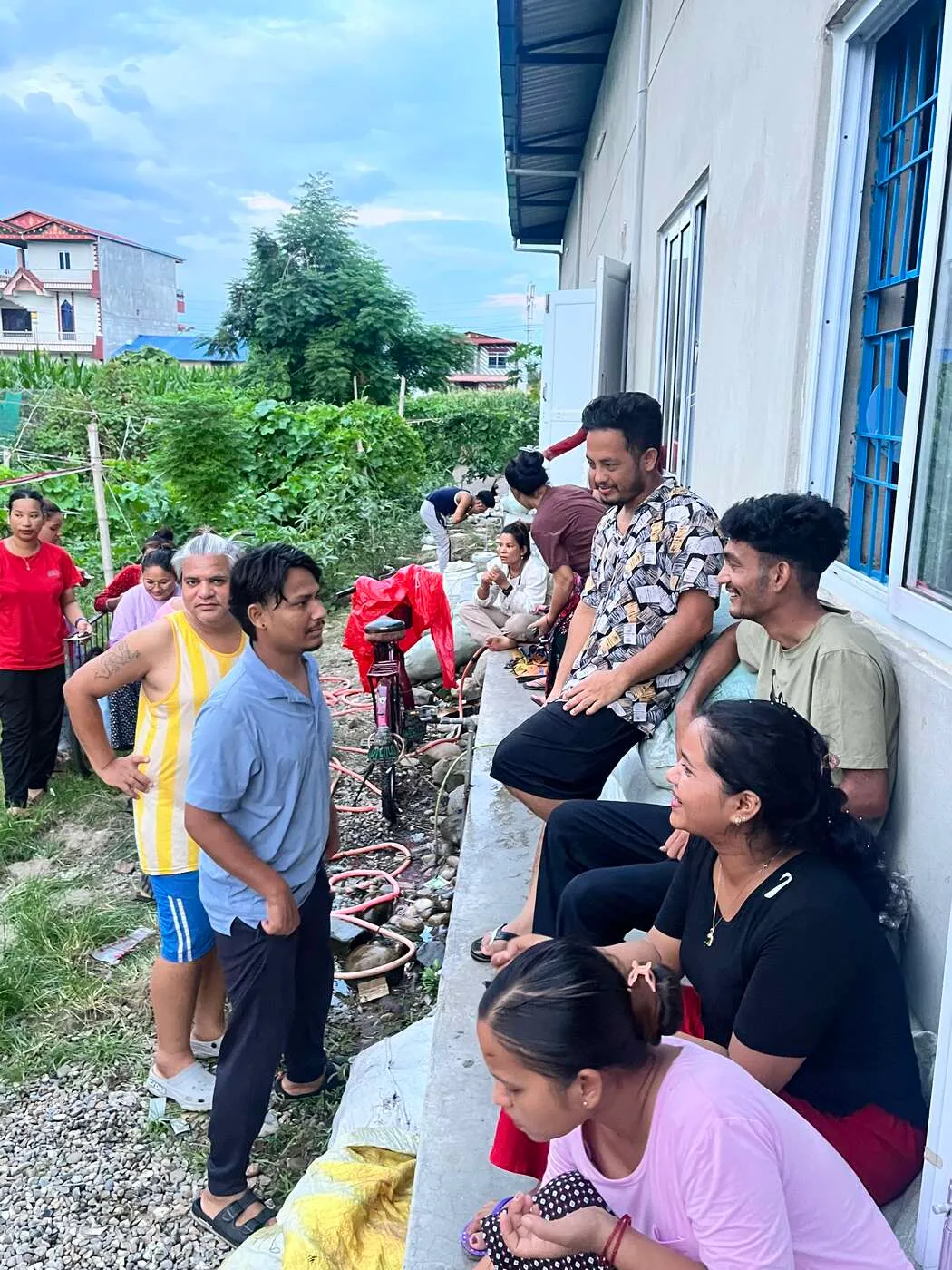 The Trishakti team gathered outside the factory in Gaindakot