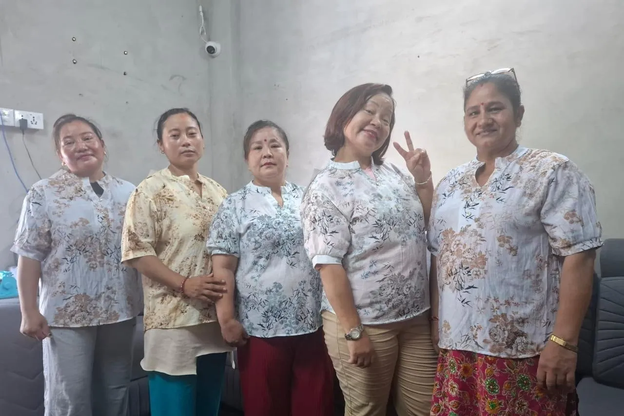 Colleagues trying our samples on across sizes, a fit check in the factory