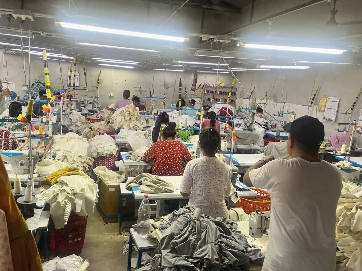 Operators at work at their machines on the Trishakti Apparel sewing floor in Gaindakot